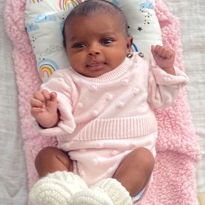 Cute light pink sweater onsie with bobble dots